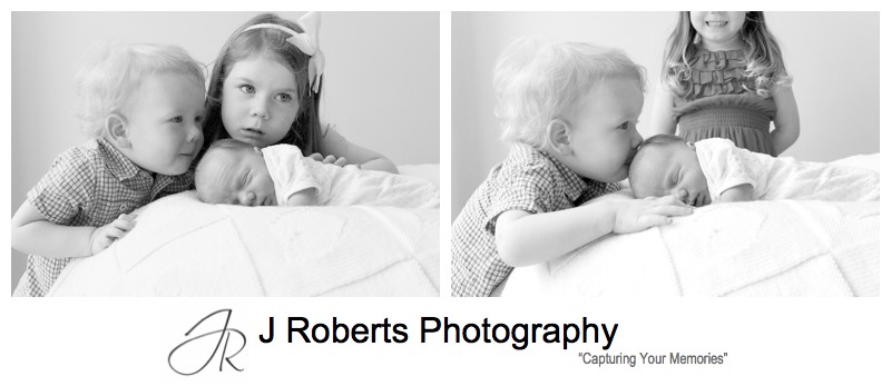 Toddler kissing his newborn brothers head- newborn baby portrait photography sydney